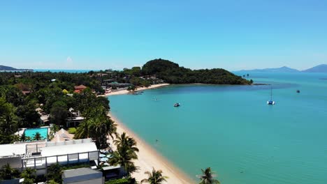 Aerial-view-of-tropical-bay-with-sand-beach-and-palm-trees