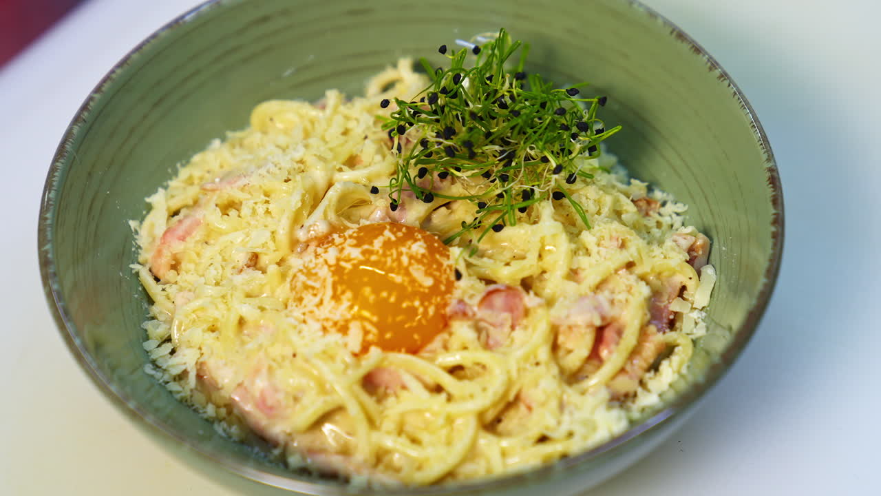 Tasty appetizer in a plate. Chef decorating delicious dish with green sprouts. Healthy food. Preparation of food in a restaurant.