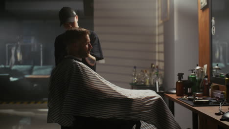 man getting a haircut at a barber shop