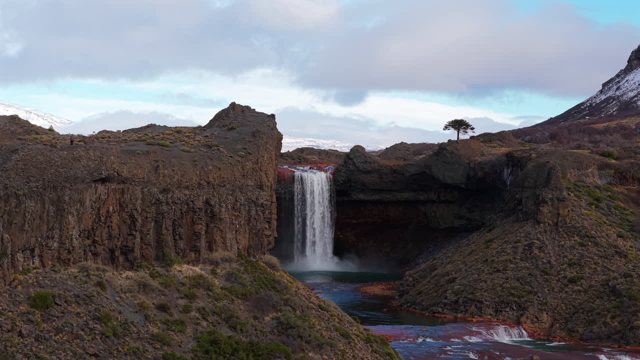 Salto del Agrio waterfall plunges over a volcanic cliff in Argentina, aerial dolly