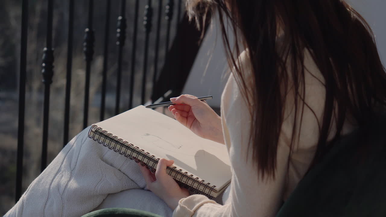 Woman Drawing on Balcony