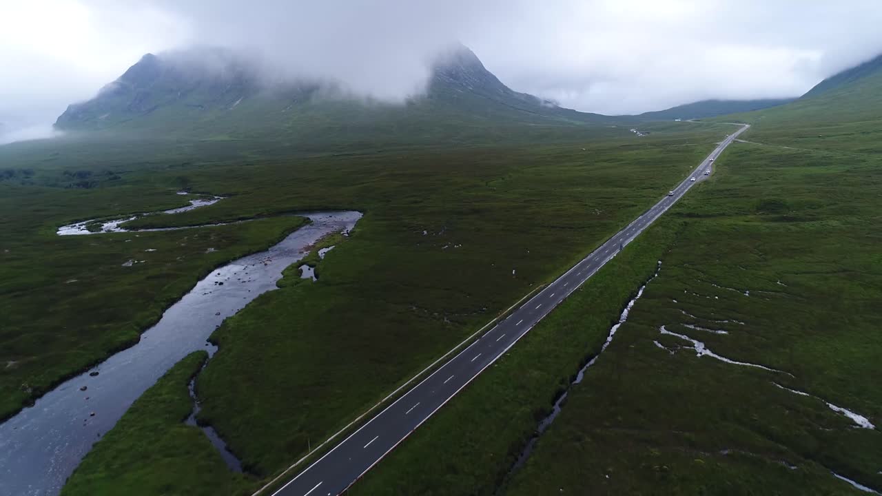 a busy road in the amazing scottish highlands during a cloudy day