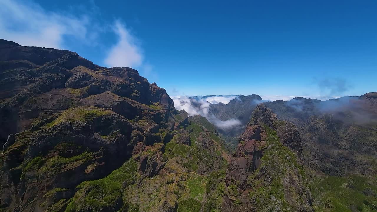 Aerial footage of the Pico do Pico trail showcasing diverse landscapes and lush greenery. Ideal for travel documentaries and nature content.