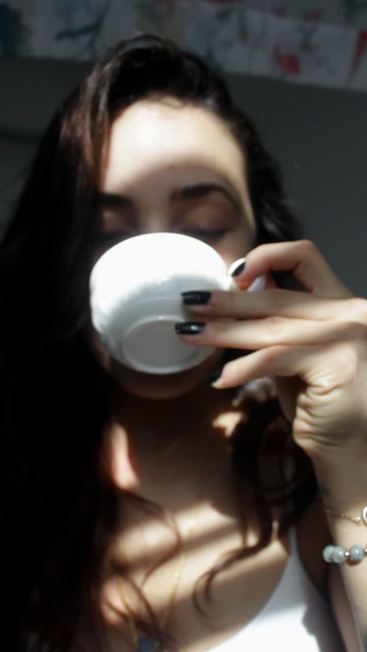 Woman enjoying a drink in the sunlight