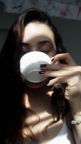 woman enjoying a drink in the sunlight