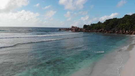 aerial view of the white beaches and turquoise waters at anse coco, petit anse and grand anse on la digue, an island of the seychelles