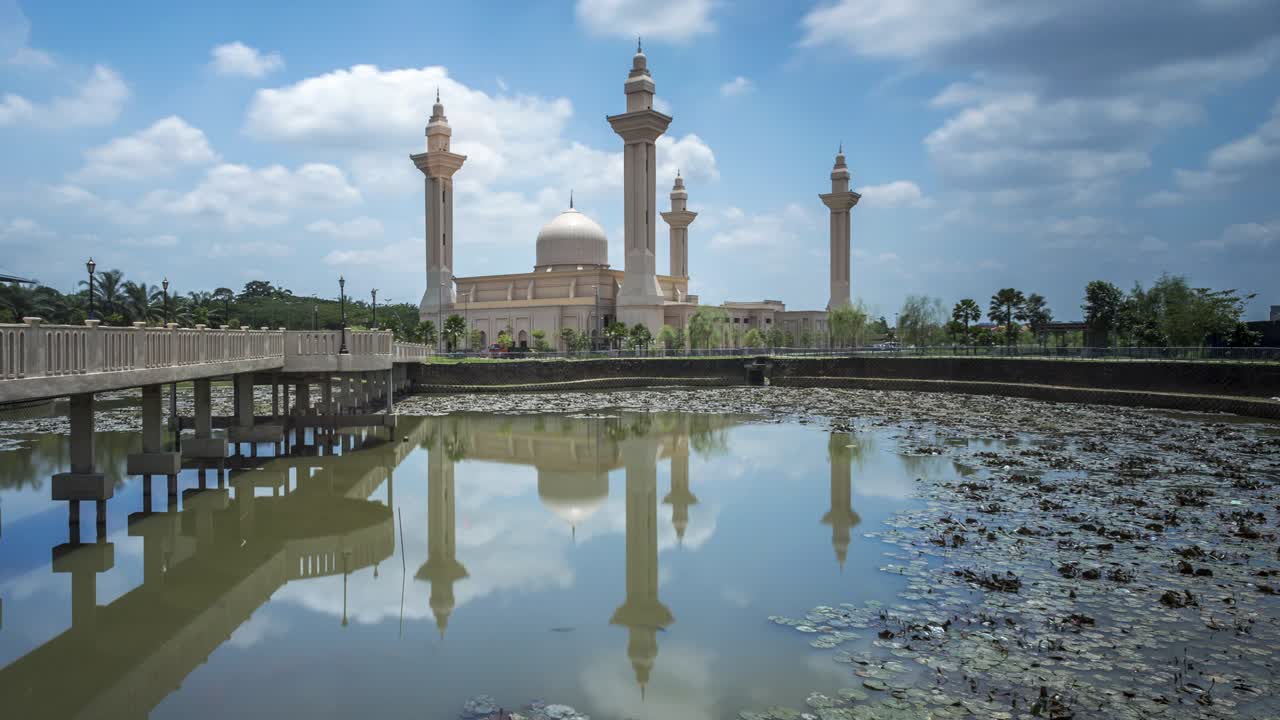 Clouds Time Lapse at a mosque. A reflection in the water.