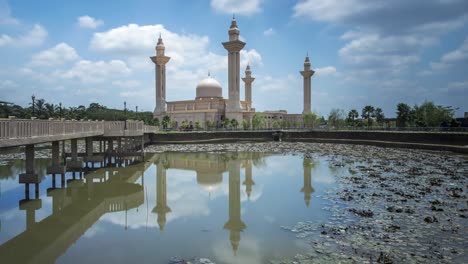 clouds time lapse at a mosque. a reflection in the water.