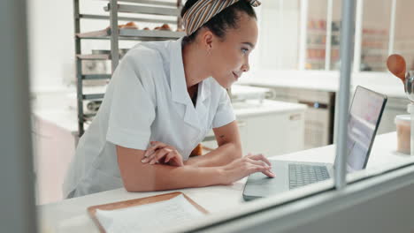 chef, laptop and woman in restaurant kitchen