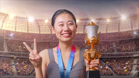 woman celebrating victory with trophy in stadium