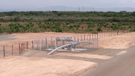 aerial view around a fenced natural gas pipe in remote wilderness