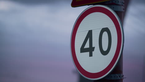 warning speed limit sign at purple sky closeup. city traffic control plate.