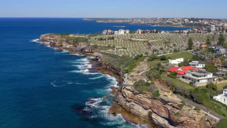 aerial view of blue sea, coastal suburb and waverley cemetery at daytime in bronte, nsw, australia