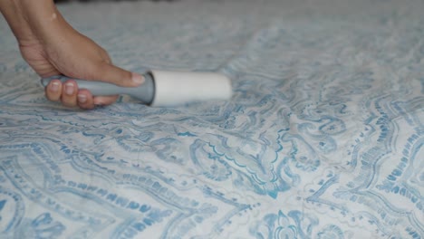 cleaning a bed with a lint roller