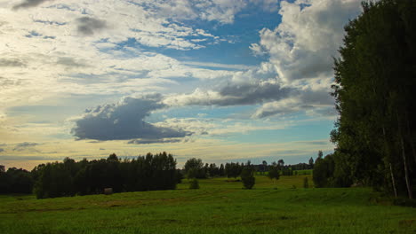 Lush-Green-Meadow,-Clouds-Forming,-Afternoon-to-Sunset,-Timelapse,-Static,-Wide-Angle