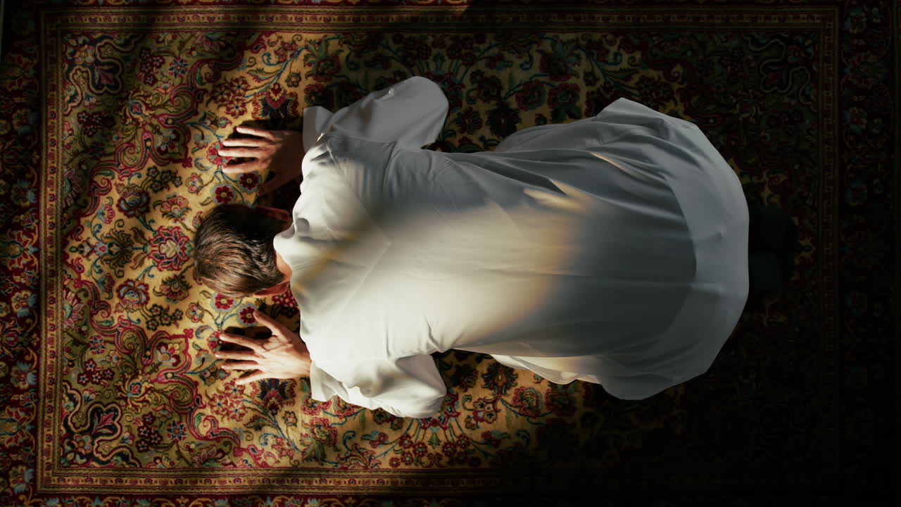 Young Man Praying On Carpet For Ramadan