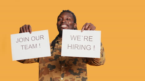 smiling recruiter showing hiring messages on papers