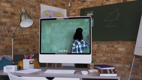 Mixed-race-female-teacher-on-computer-screen-during-video-call