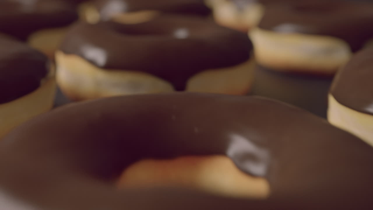 Chocolate glaze donuts on a dark background