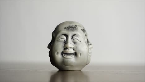 laughing buddha figurine with three faces