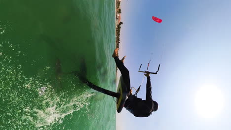 sitting down while foiling on a hydrofoil kite surfing board