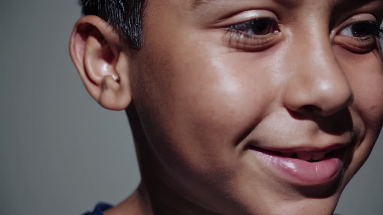Close-up video shot of a child's face, capturing deep emotion. The angle focuses on the eyes
