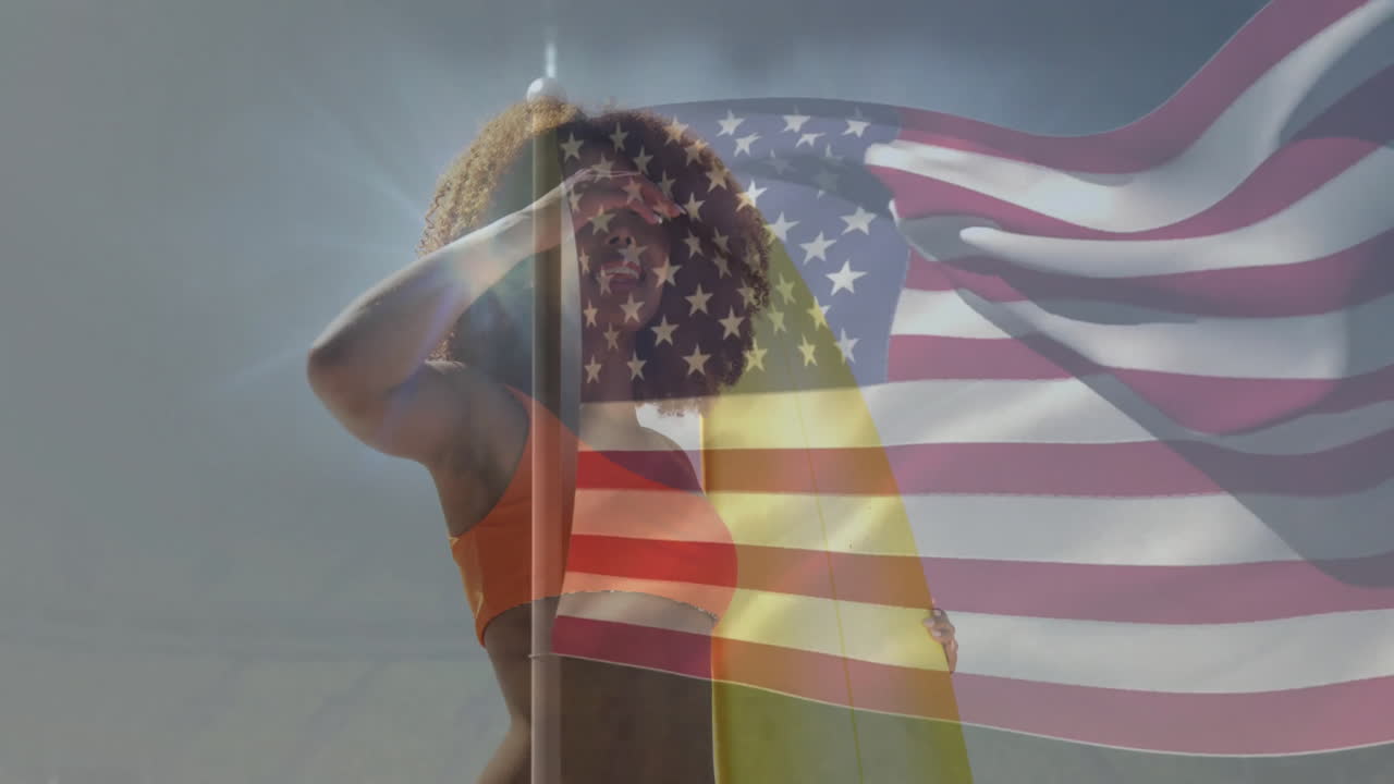Posing with American flag overlay, woman in orange swimsuit against backdrop