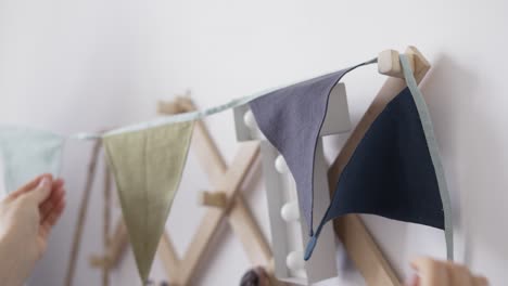 decorative triangular small flags made by female tailor indoors