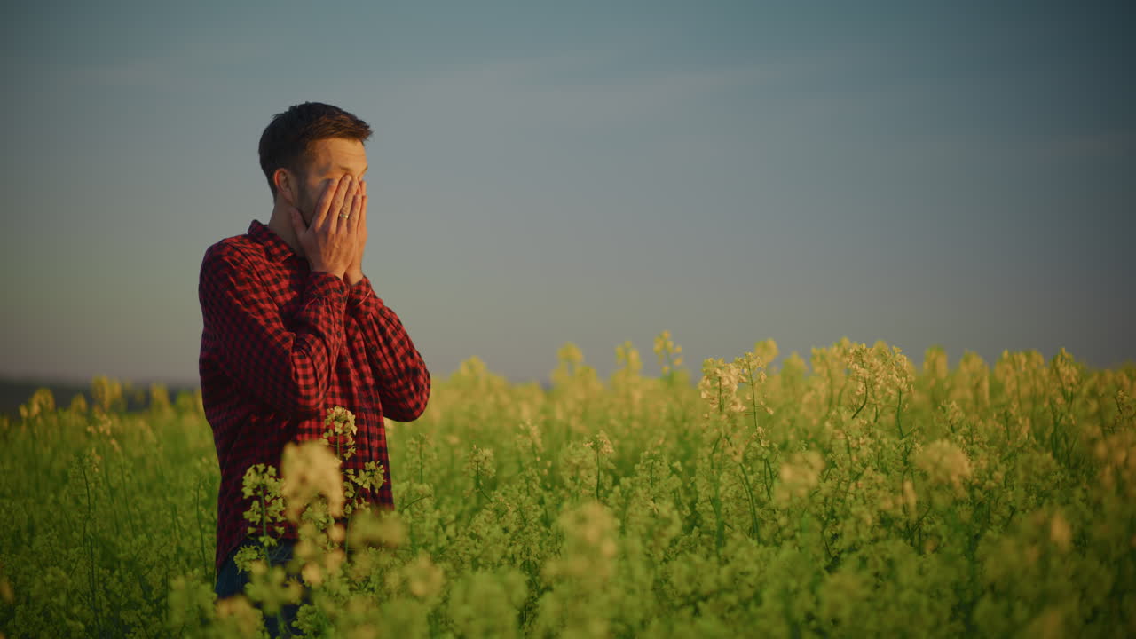 Sad Man Standing in Rape Field