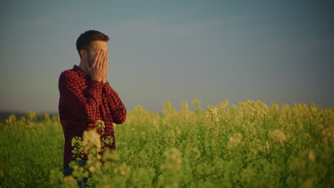 sad man standing in rape field
