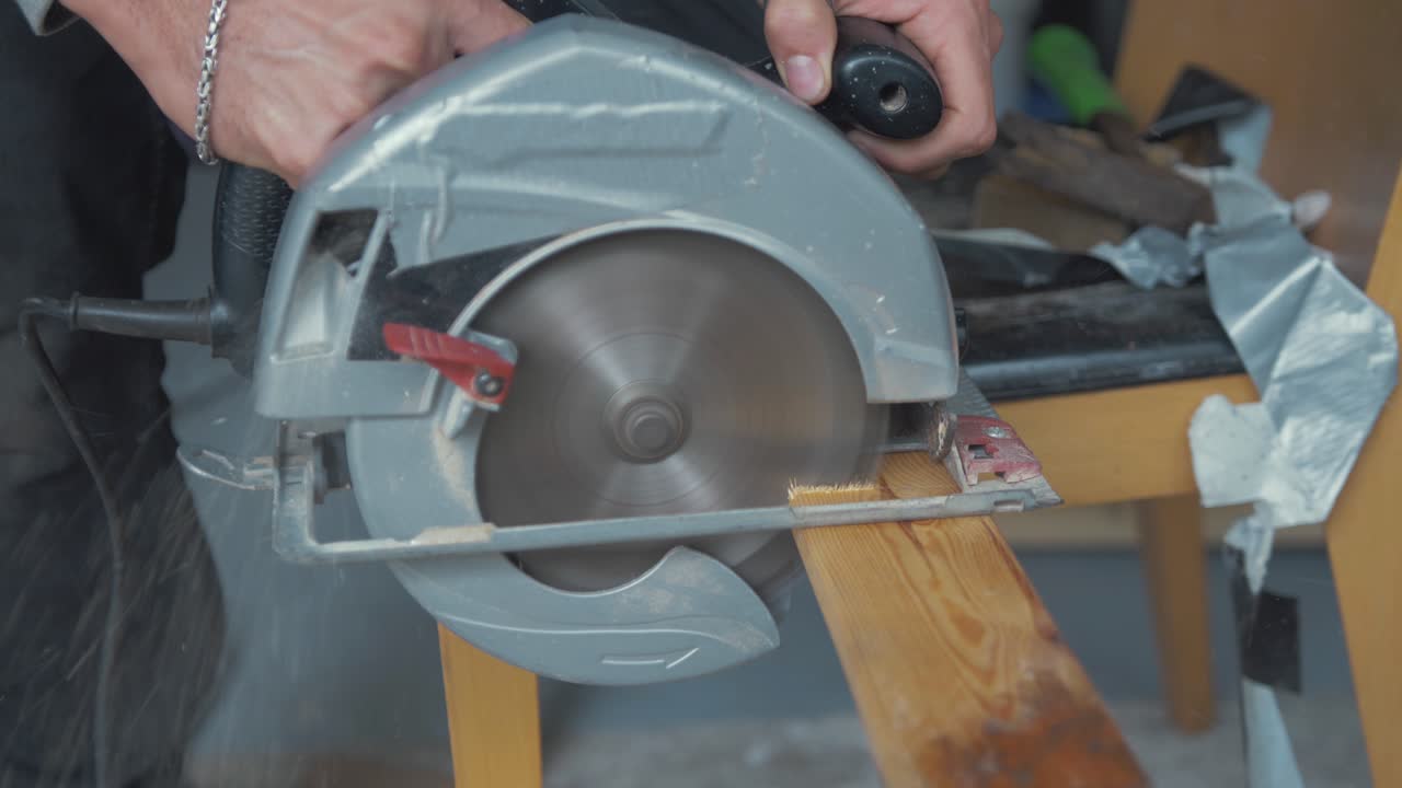 Using circular saw to cut pine timber plank, Slow motion. Close up