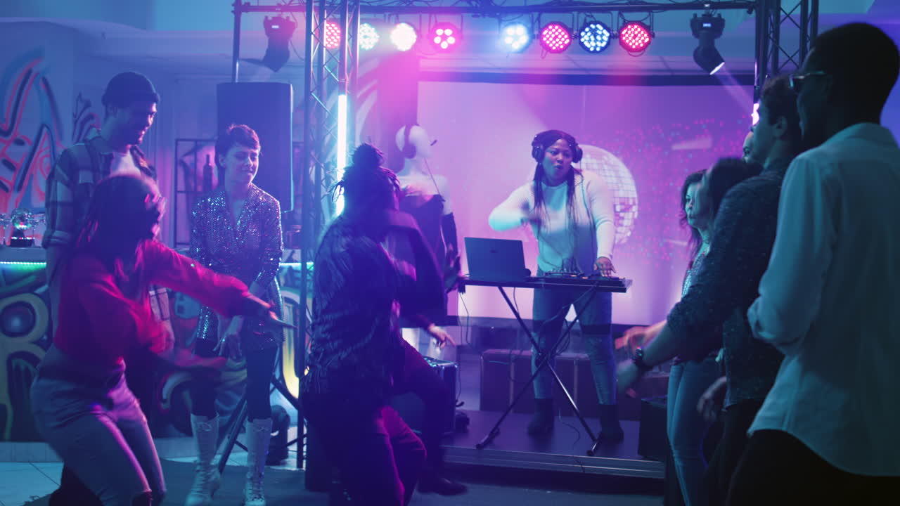 People dancing at a nightclub party with a DJ