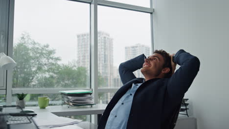 happy manager throwing papers finishing project. joyful businessman lean chair