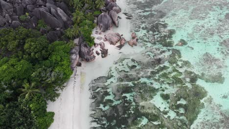 Aerial-view-of-Anse-Source-d’Argent,-La-Digue,-Seychelles-shot-in-the-early-morning-hours-with-no-people-on-the-beach