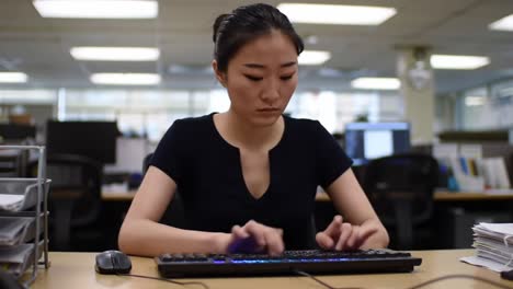 focused individual engaged in computer work in an office setting, highlighting concentration and productivity in a modern work environment