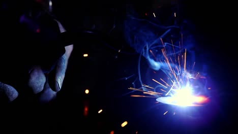 Close-up-of-welder-working-on-a-piece-of-metal