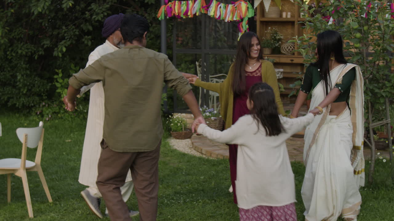 Joyful Indian Family Dancing in a Garden Celebration