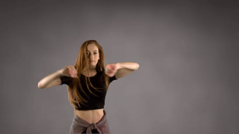 woman dancing against grey background