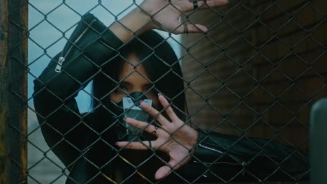 mysterious woman behind a fence
