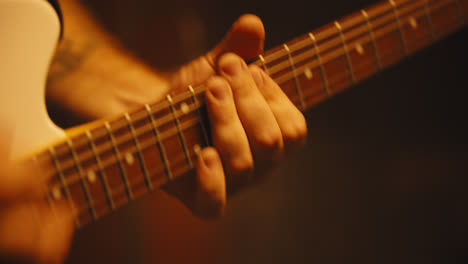 close up of fingers playing electric guitar-1