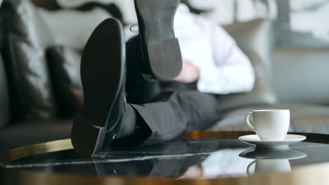 businessman relaxing on a couch with coffee