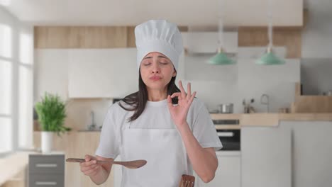 happy indian professional chef tasting her food