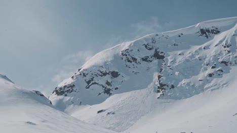 Snow-covered-mountain-landscape-in-Norway,-handheld-view