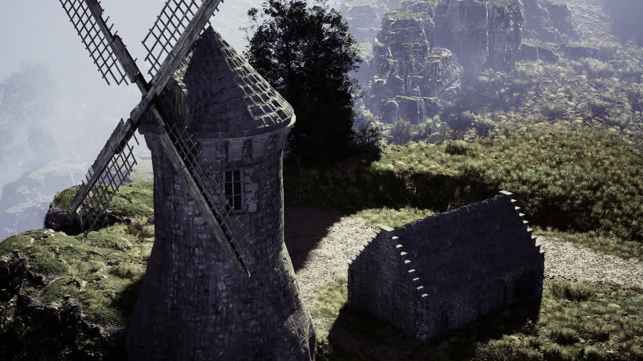 Historical windmill stands majestically on rocky landscape during golden hour