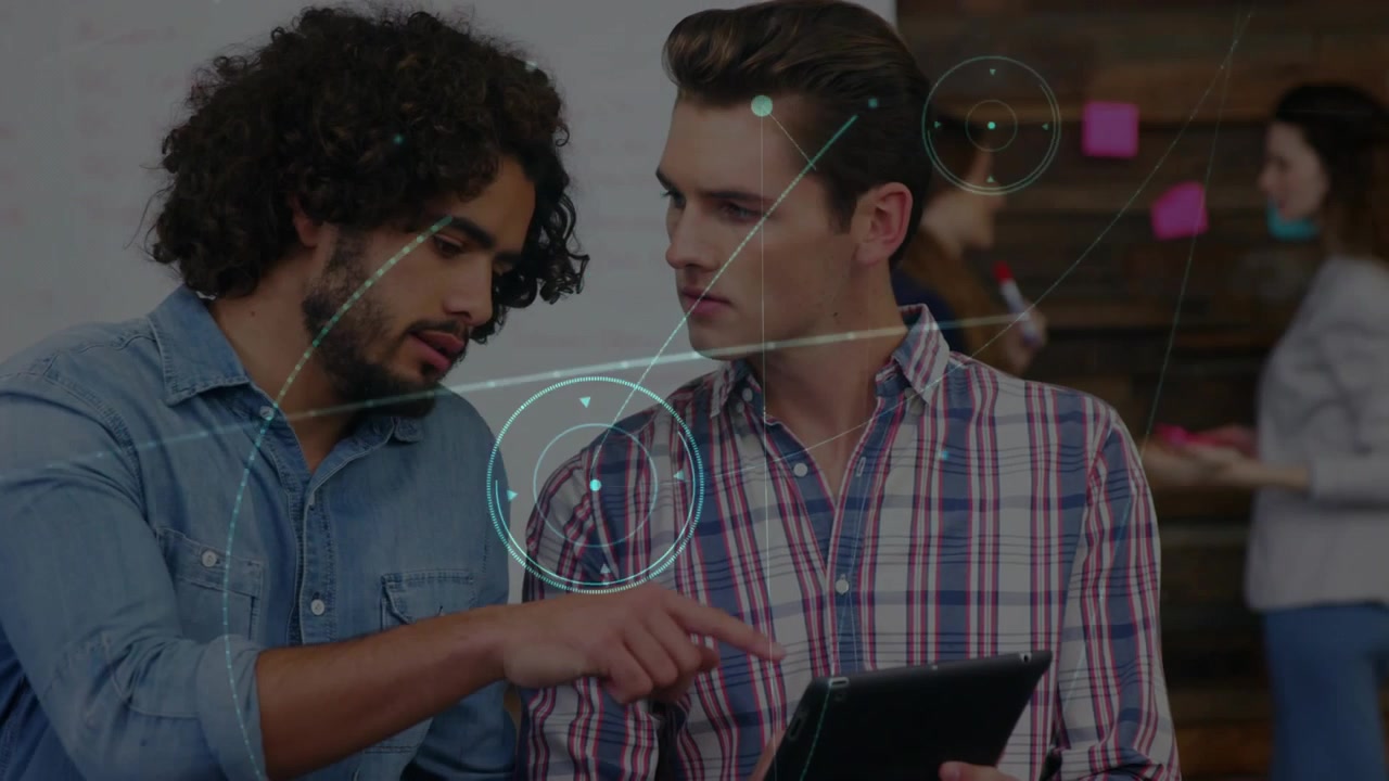 Colleagues tapping tablet to analyze business data in office generating animated data overlays