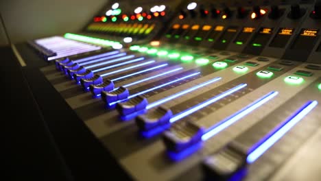 tv mixer panel with colorful buttons moving fast controlling audio and video broadcast