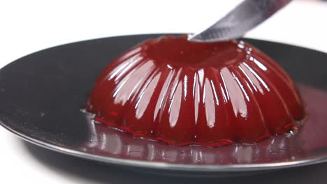 red jelly dessert on black plate