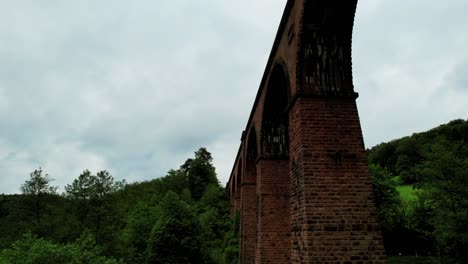 Brick-railway-bridge,-historic-viaduct-between-green-hills