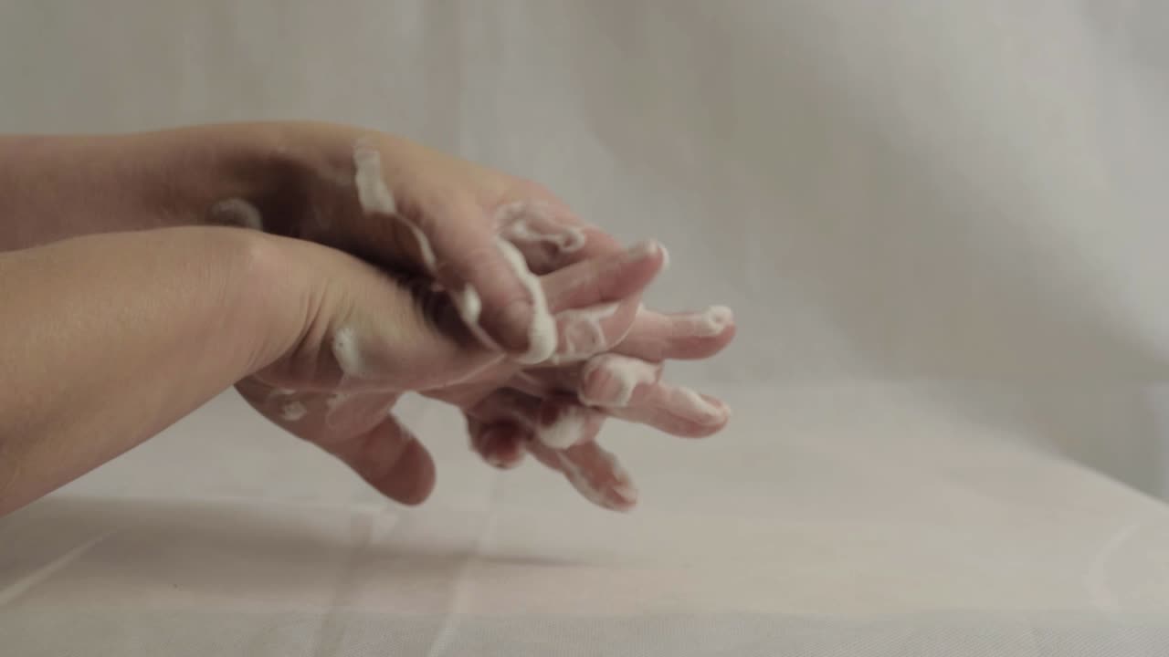 Washing hands with soapy water wide shot