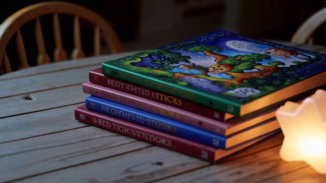 children's books and nightlight on wooden table